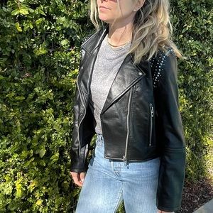 Blank NYC faux leather coat with studs and turquoise details.